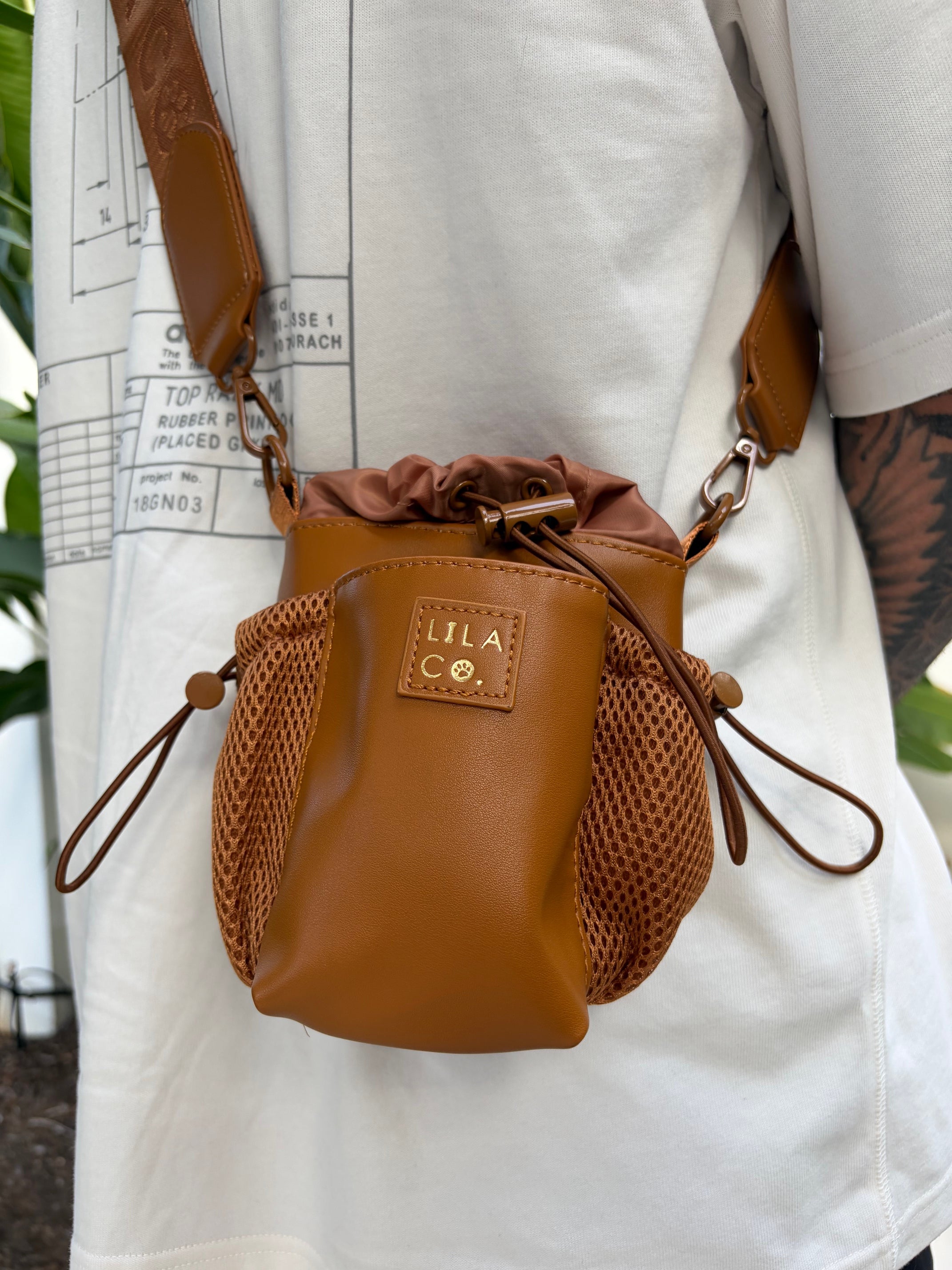 Brown leather pouch with drawstring on a white surface