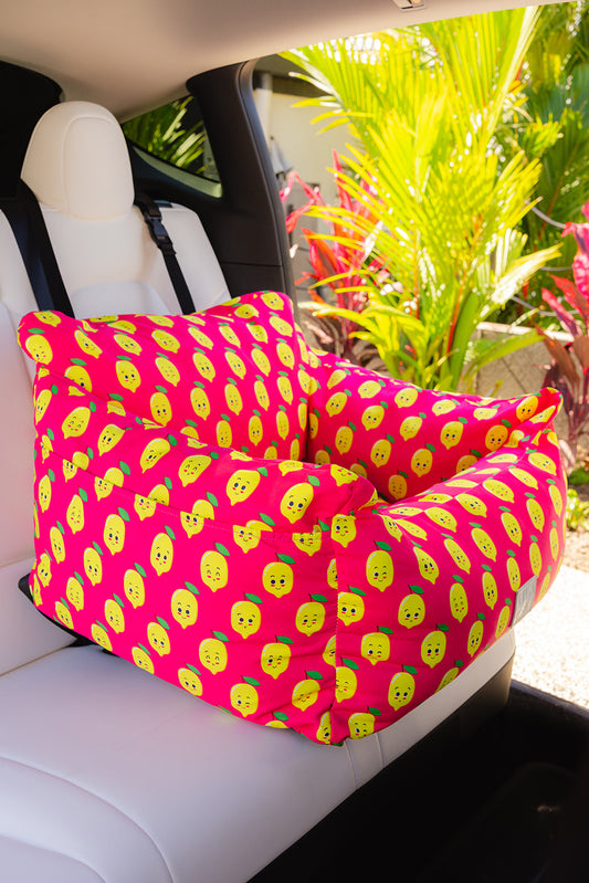 Pink donut animals print water resistant dog car seat bed front view in car