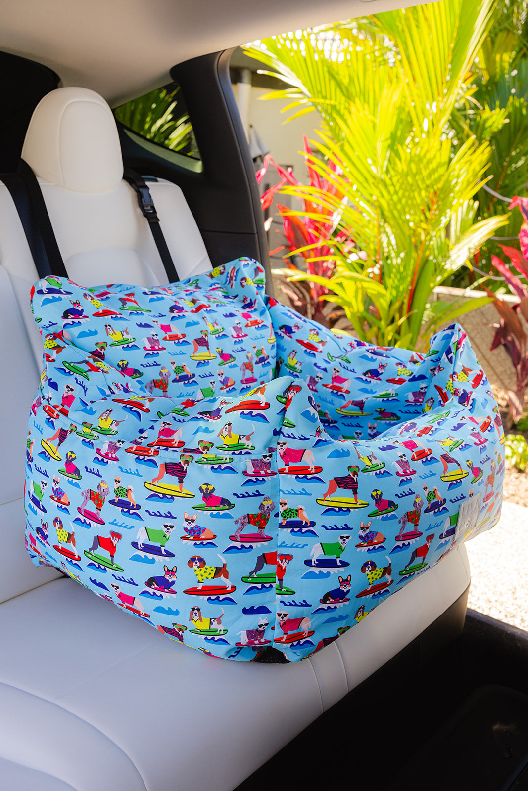 
                  
                    Blue surf dogs print blue water resistant dog car seat bed front view in car
                  
                